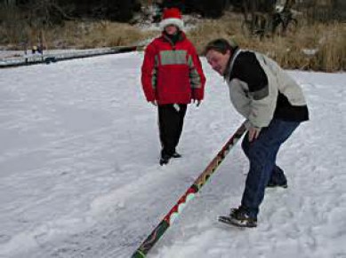 Watch how to play the snow snake game